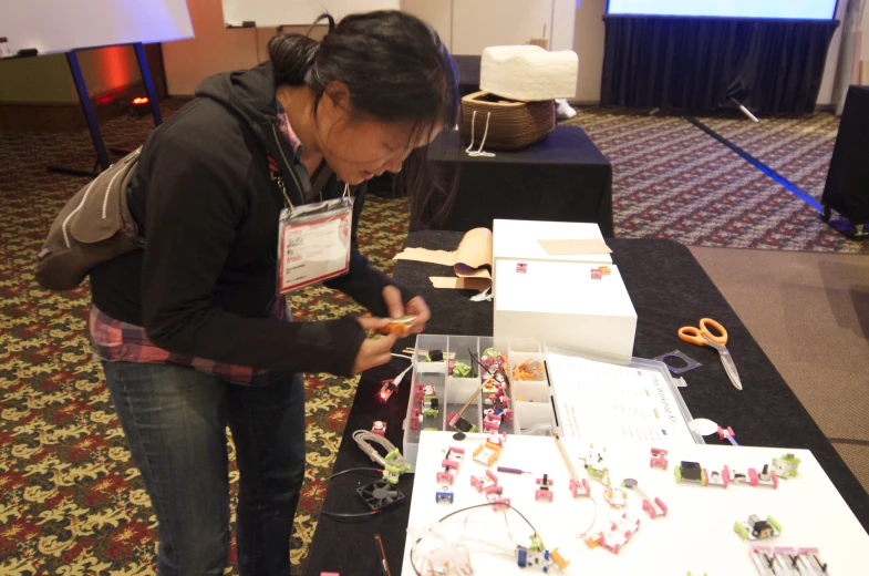 a woman is trying out a piece of equipment on a table