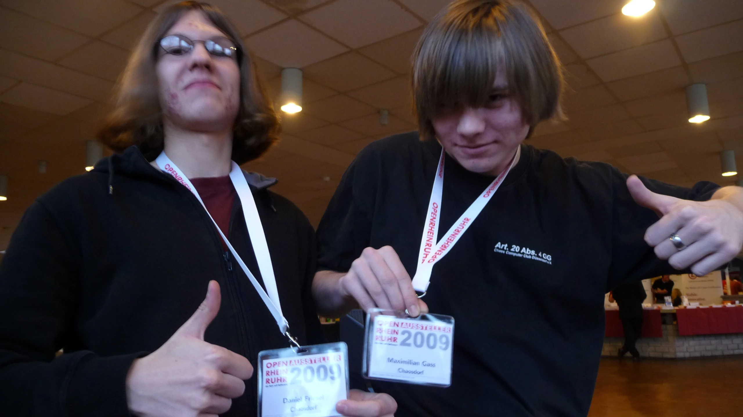 two male students pose for a picture at a conference