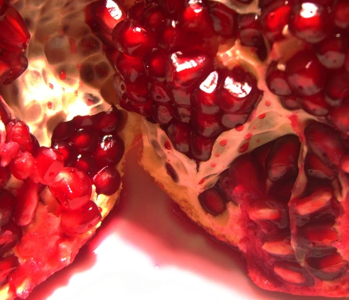 the cut in half of a pomegranate on a white plate