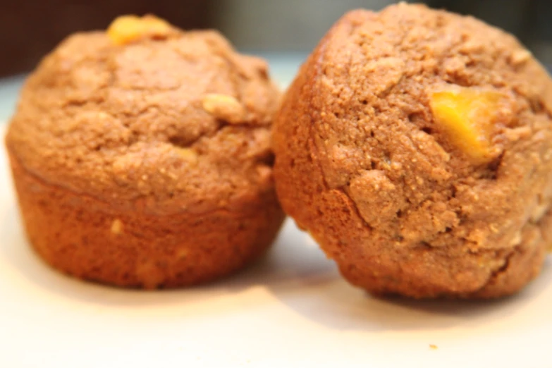 two pieces of a muffin on a white surface