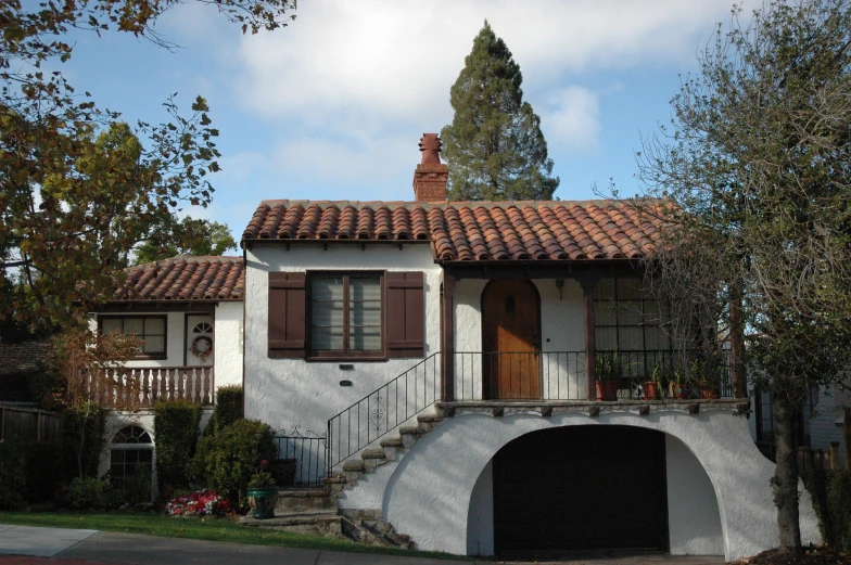 a house with a staircase on the front is white