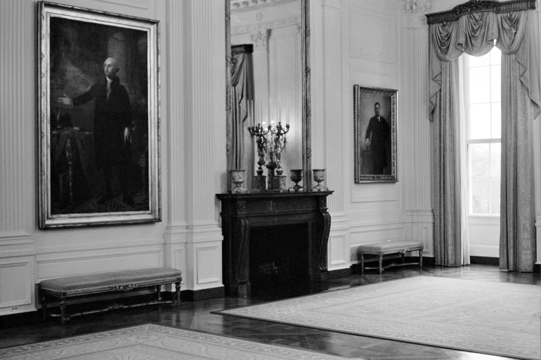 this black and white po shows an interior with several paintings