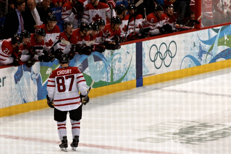 a hockey player walking toward an ice rink