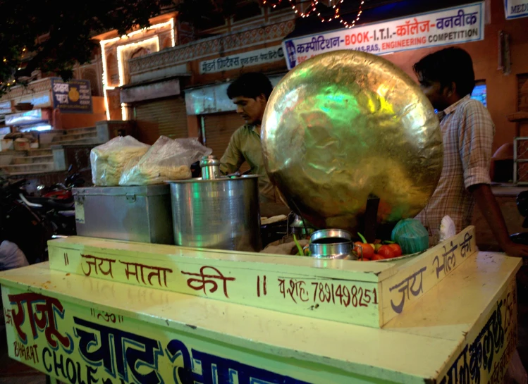 people in front of a large serving station at a market