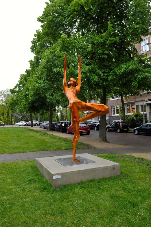 there is a statue of a person doing yoga outside