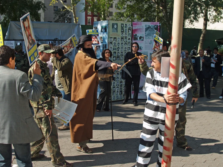 man in a  cell costume holding scissors while other people stand behind him