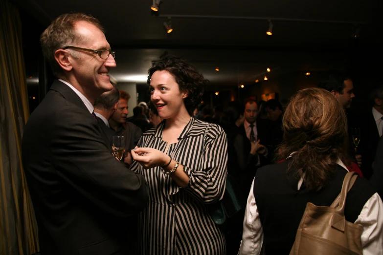 two people are congratulating each other at a party