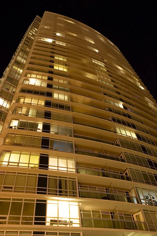 a very tall building with many windows at night