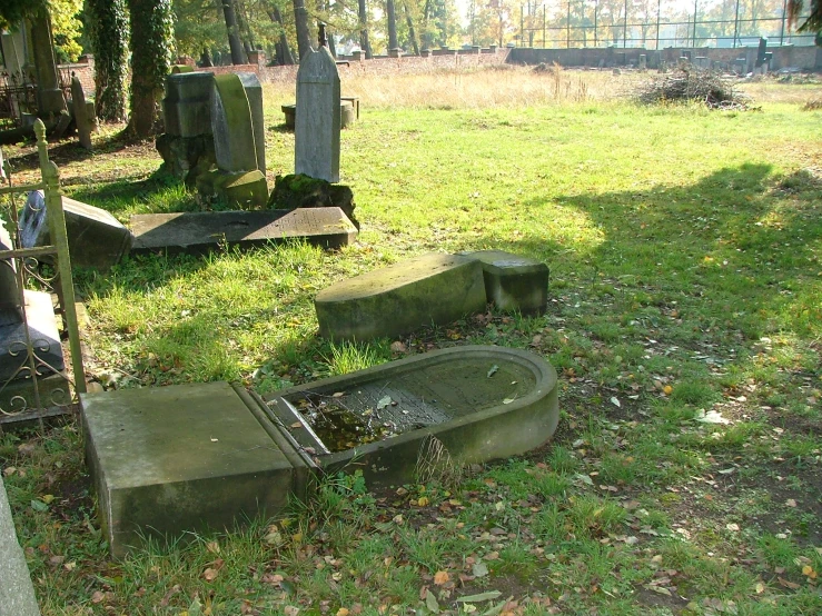 a row of cement sinks near a cemetery