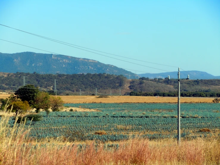 an empty field with hills in the background