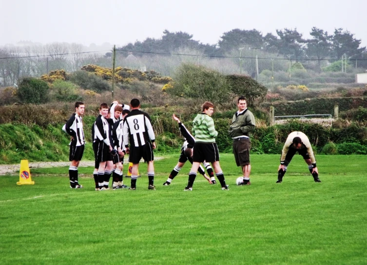 men in soccer jerseys standing on a field