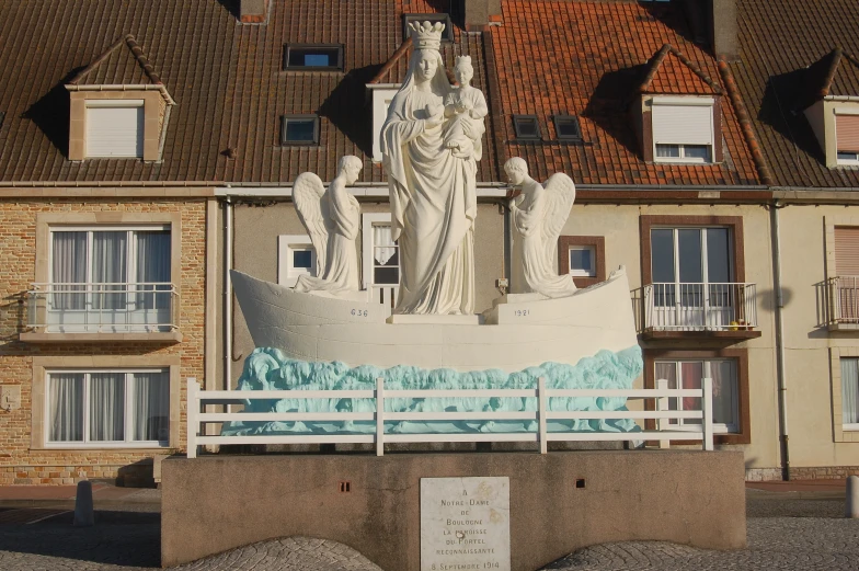 a statue with two statues of women around it