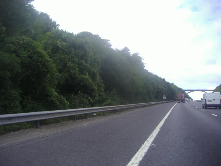 a truck is riding down the road in the day