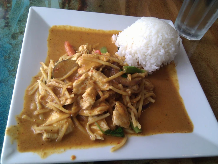 a bowl of food with rice and some kind of meat