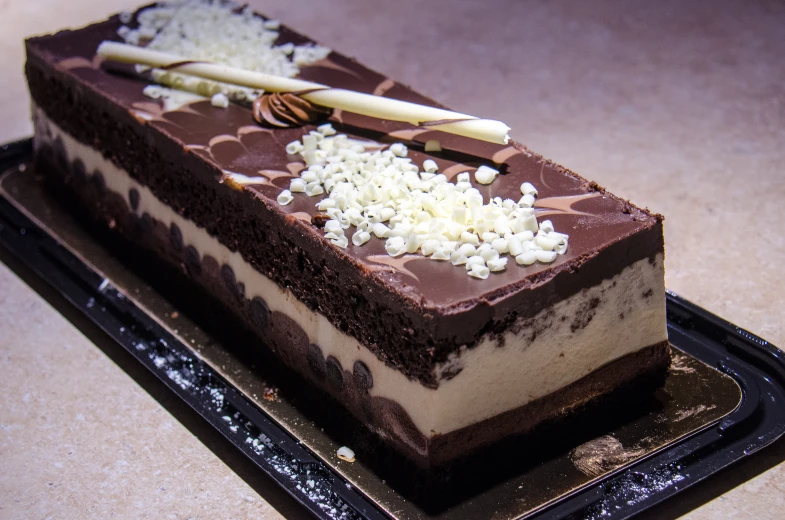 there is a chocolate and white dessert on the platter