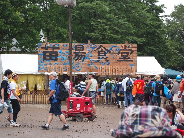 crowd of people gathered around a sign on a pole