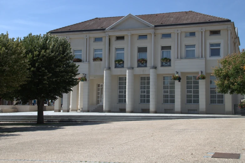 the building has two windows and trees around