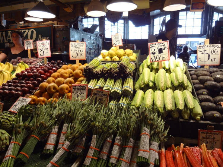 several piles of fruits and vegetables at a grocery store