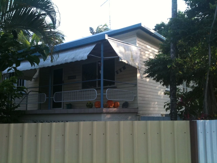 a building has a fence and a tree by it