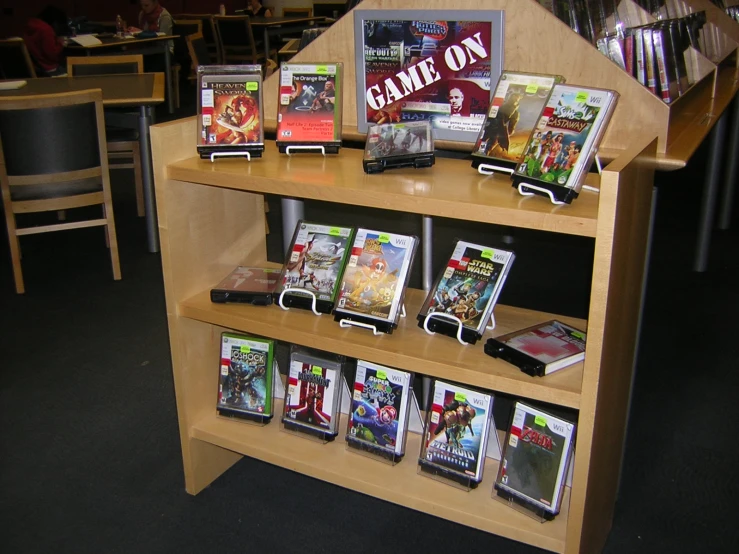 a variety of video games sitting on wooden shelves