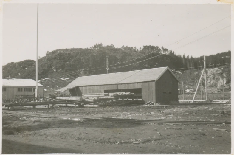 black and white po of a farm with hay and a shed