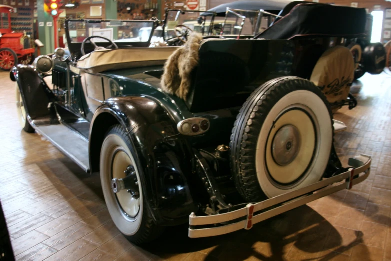 an old time car sitting on display in a museum