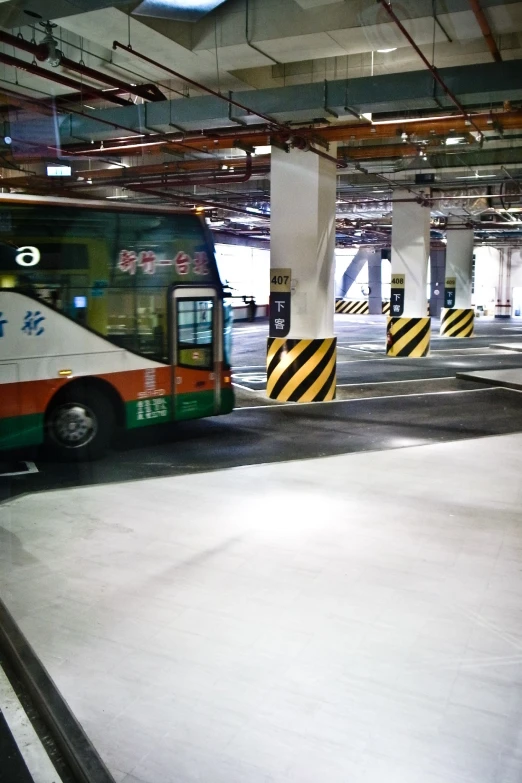 a public transit bus sitting in a parking garage