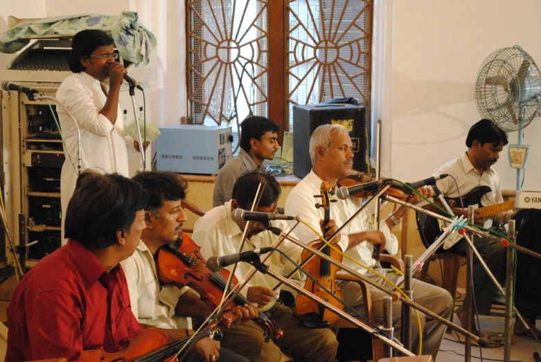 several people are playing instruments on a stage