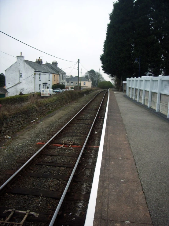 a empty train track beside a building