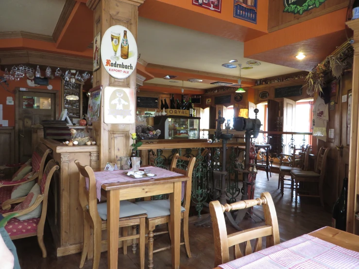 an old bar with many chairs is shown