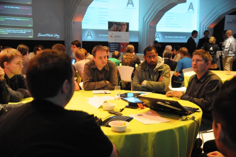 people sit around a table talking at the conference