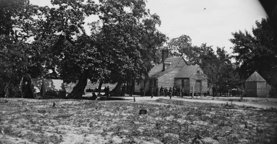 the large home is next to the many trees