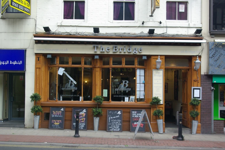 a street view of a building with windows that are filled with signs and menus