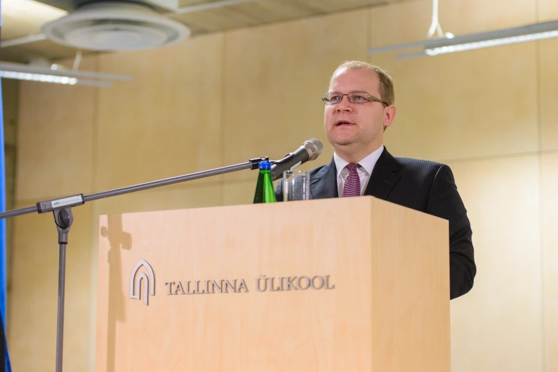 a man giving a speech at a podium