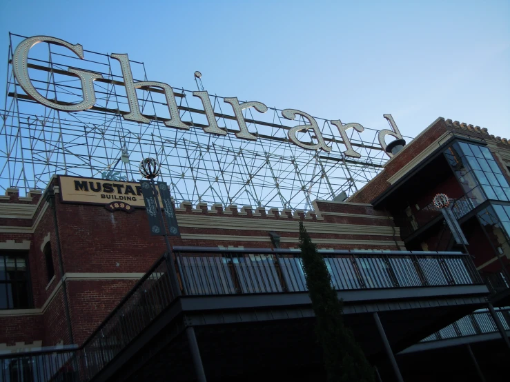 the sign on top of the building has many metal bars hanging