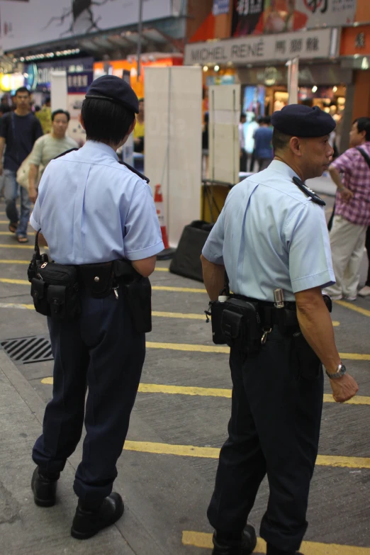 two police officers standing on a street corner