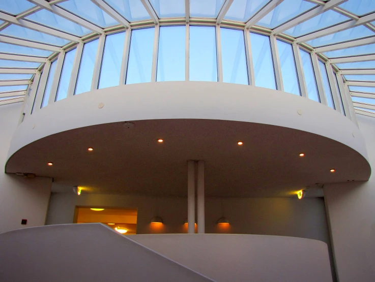 a stairway up to an indoor glass and steel building