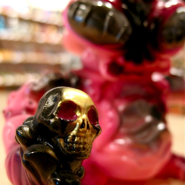 a skull figurine standing on a counter in front of a store