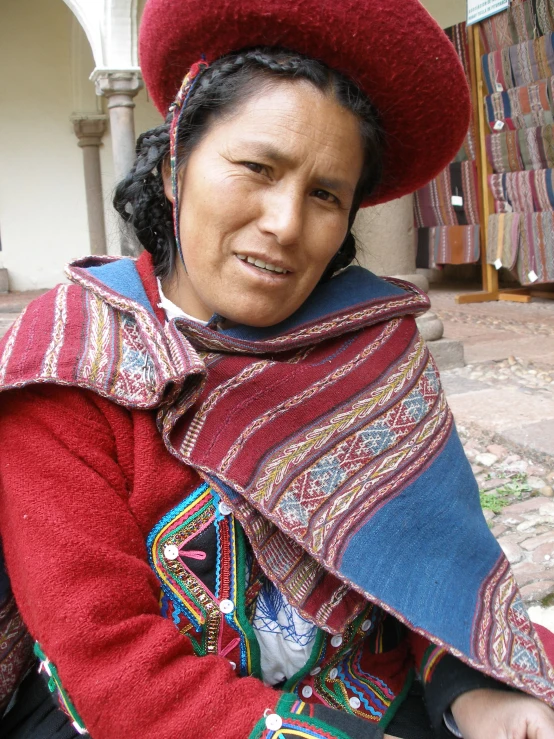 the lady is wearing a red hat and a blue scarf