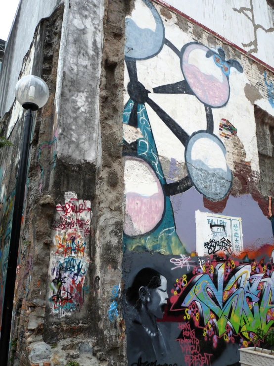 a large graffiti covered wall next to street lights