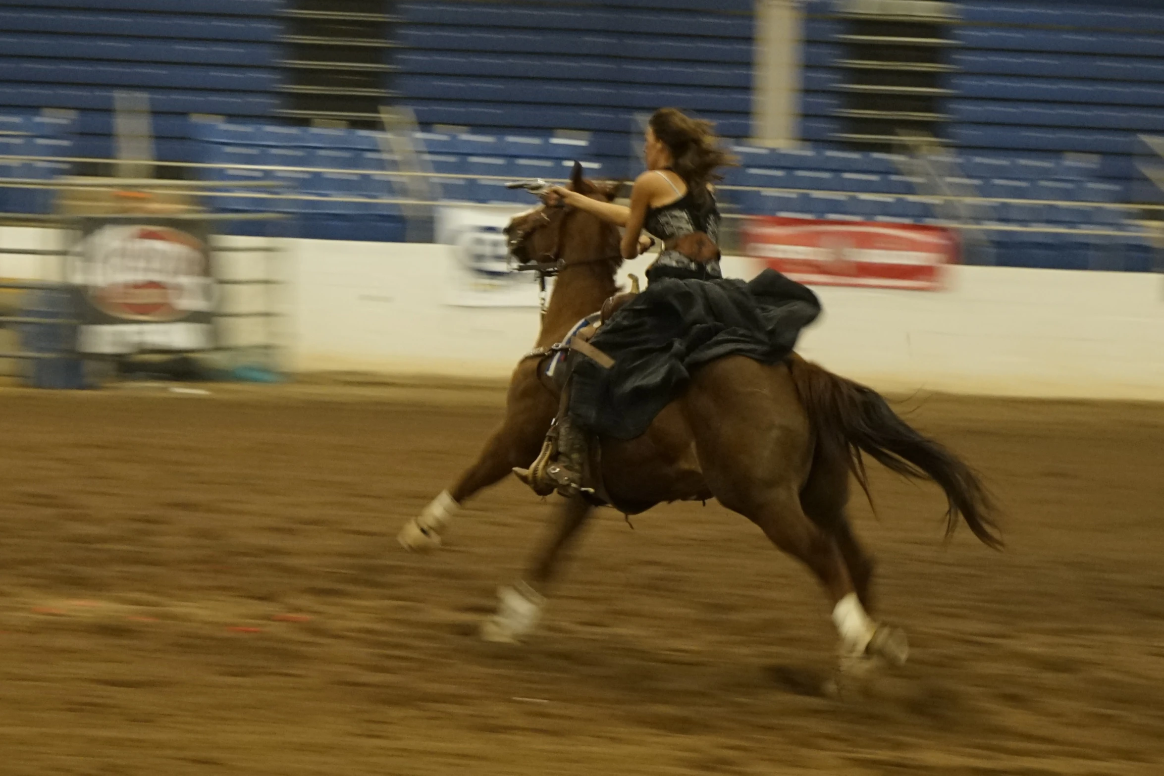 the rodeo rider is in the saddle while the horse runs by