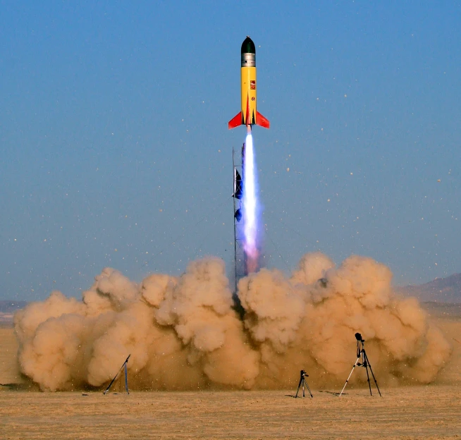smoke billows from a rocket on the ground