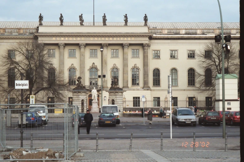 people walking near a very large white building