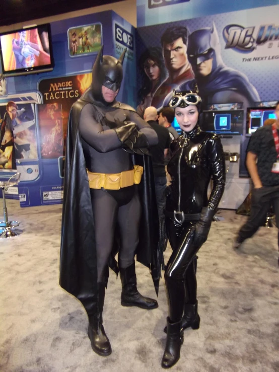 a couple dressed as batman and a batman villain