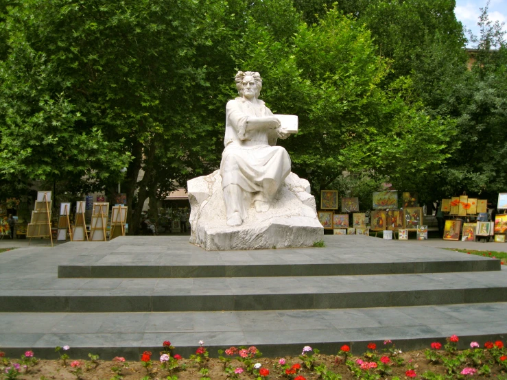 a statue of a woman holding a bird in her right hand