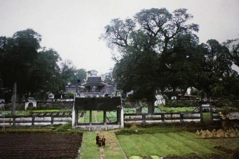 two people walk down the path towards an elaborately decorated structure