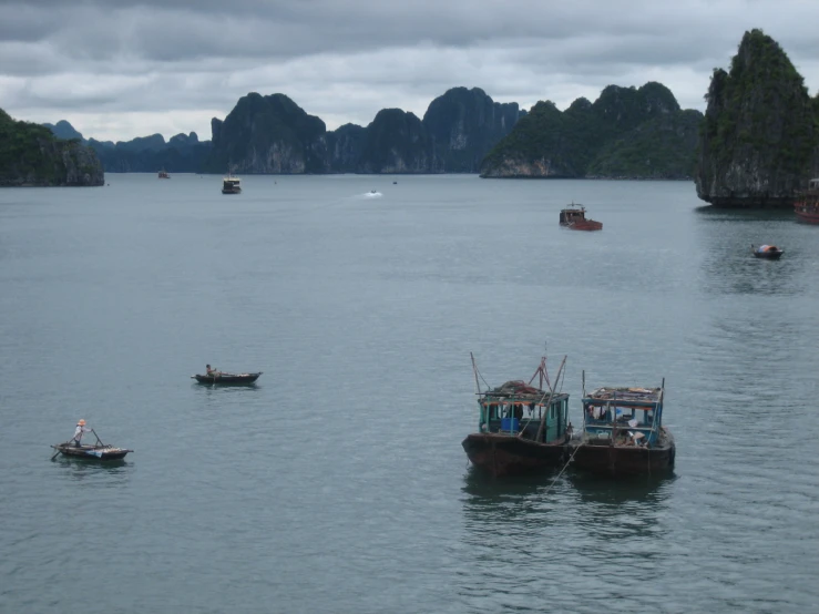 small boats in an island with rock formations