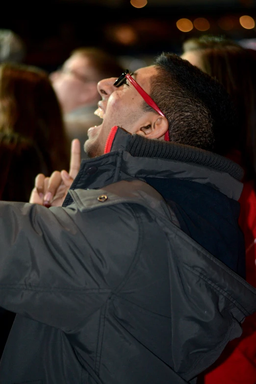 a man is singing and looking off into the distance