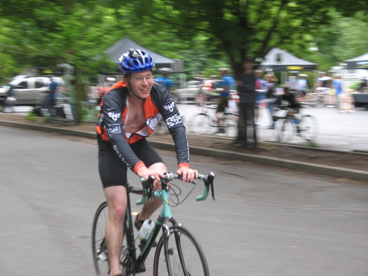 a man riding a bike wearing a helmet and sunglasses