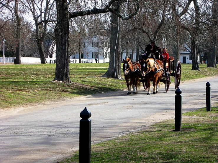 three horses pulling a wagon and two men